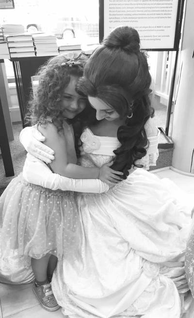 Belle gives hugs at a princess storytime 