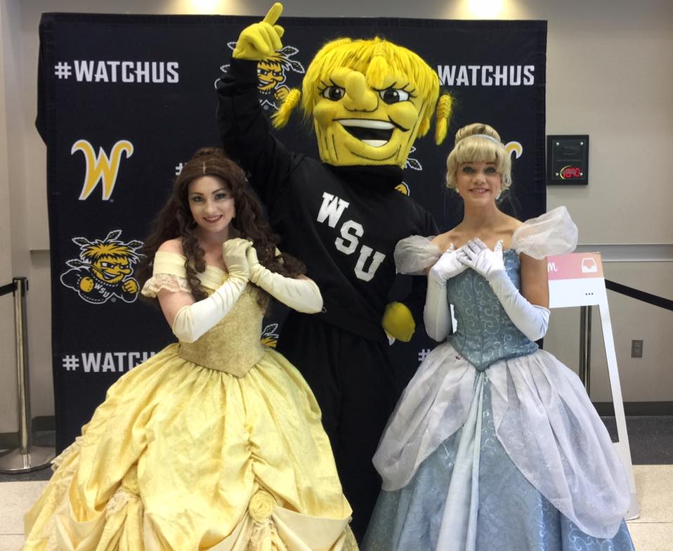 Belle and Cinderella pose at a local event