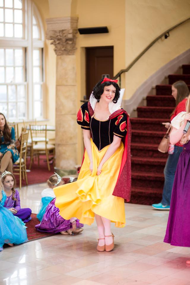 Snow White giggles at the party with little princesses