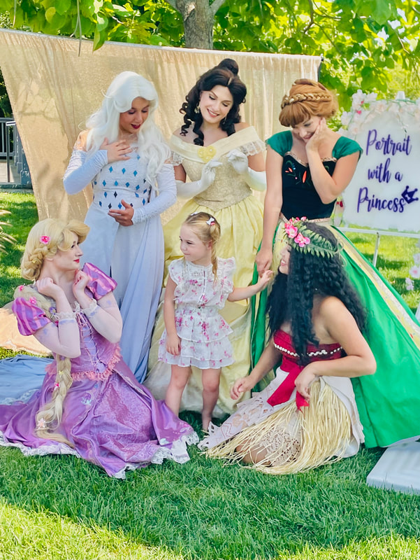 Elsa, Belle, Anna, Rapunzel, and Moana pose with a birthday child in the Hamptons