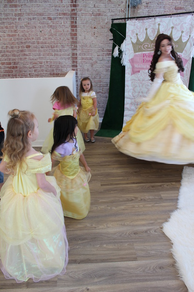 Belle dances with little girls dressed in princess dresses