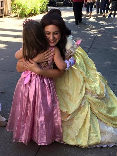 Belle hugs a little girl 