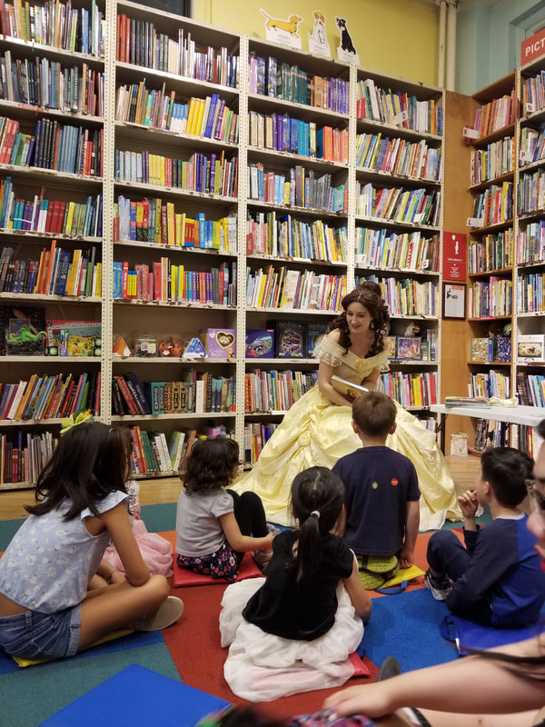 Belle reads a princess story to excited kids at a daycare visit in NYC